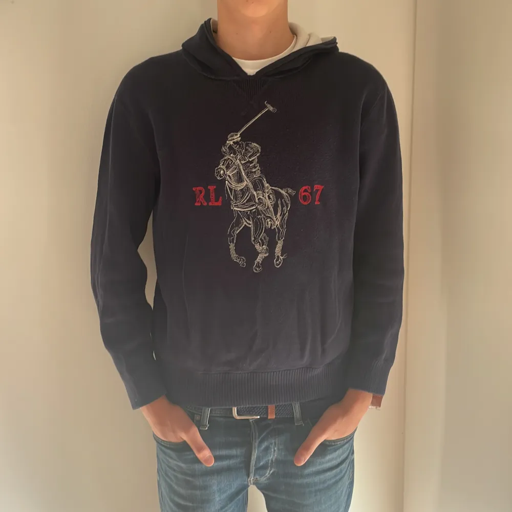 Säljer en snygg mörkblå hoodie från Ralph Lauren med det klassiska polospelarmotivet och RL 67 i rött. Perfekt för en casual look, den är både bekväm och stilren. Passar bra till jeans eller chinos. Hör av dig vid intresse! 💙. Tröjor & Koftor.