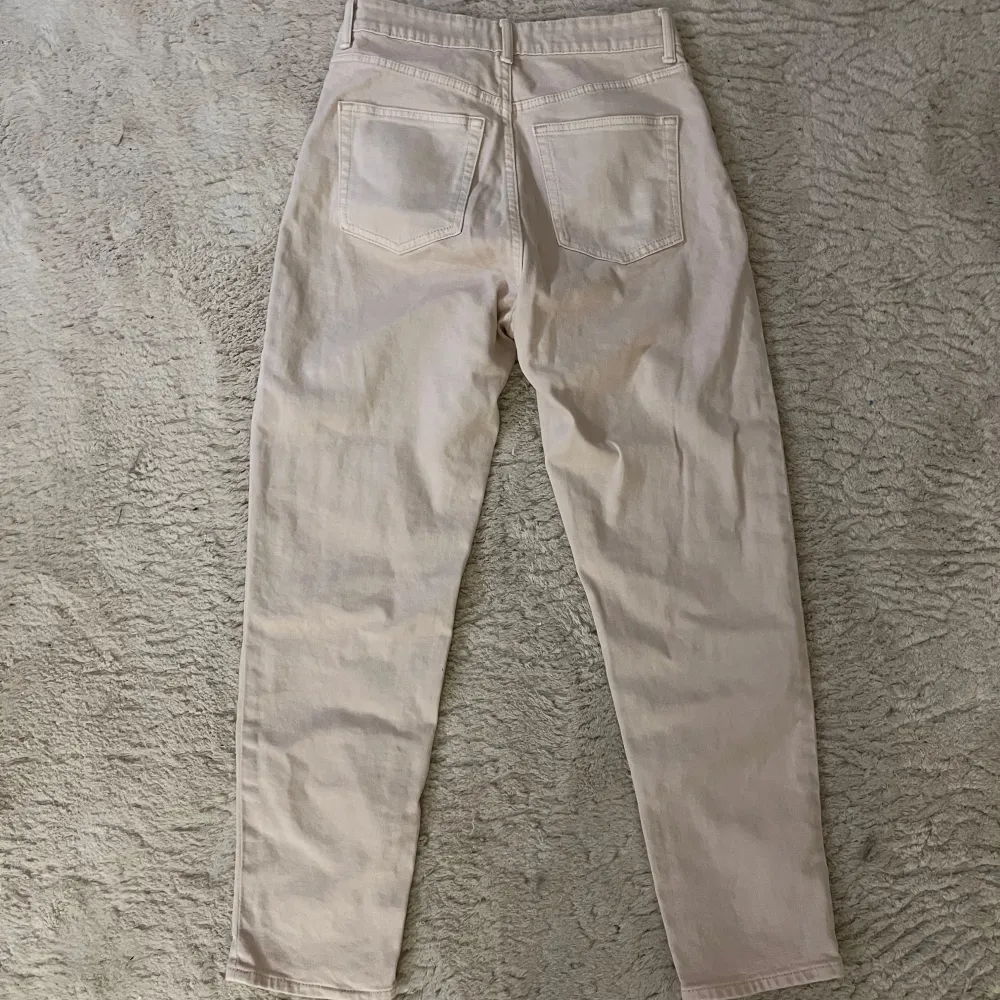 Säljer ett par snygga beige jeans från H&M i storlek 38. De är högmidjade med en straight passform och klassisk femficksdesign. Perfekta för både vardag och fest! 🥳. Jeans & Byxor.