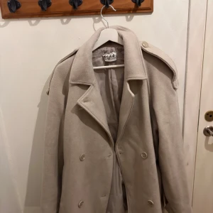 Beige kort kappa - Beige kort kappa från Na-kd, använd ett fåtal gånger och i mycket bra skick! 