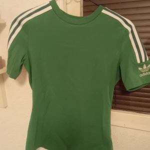 Adidas kortärmad tröja  - Säljer en kortärmad tröja ifrån adidas, strl M, mycket bra skick, en liten fläck (kolla sista bilden) går bort i tvätten! Tröjan är finare grön än på bilderna! Säljer den för 50kr + frakt! 