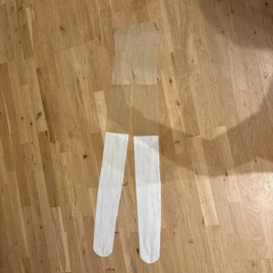 Vita tajts som ser ut som knästrumpor från Dolly Style - Detta är ett par tajts som ser ut som att du har knästrumpor på dig. De är från Dolly Style och är aldrig använda. De säljs häller inte längre på deras hemsida och är i storleken One size.