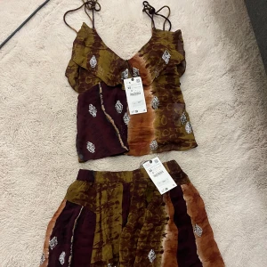 Mönstrat sett med paljetter - Så snyggt mönstrat sett från Zara i olivgrön, brun och orange färg. Kom aldrig till användning tyvärr och är helt oanvänd med prislapparna!