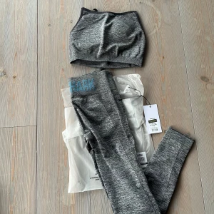 Gymshark träningsset XS-S - Charcoal marl flex high rise träningsset. Tightsen är oanvända och toppen har endast blivit använt ett fåtal gånger. Skickas i förpackning. Tights: XS Top: S  Kika gärna in på mina andra annonser, säljer fler träningskläder från bla aimn, Gymshark, ICIW och kan samfrakta!