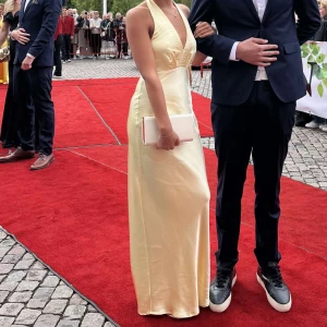  Gul balklänning - Säljer min gula balklänning, använd en gång. Superfin o bra skick! Köpte för 1300! Har en fläck på bilderna för att jag spillde men fläcken är inte kvar nu!