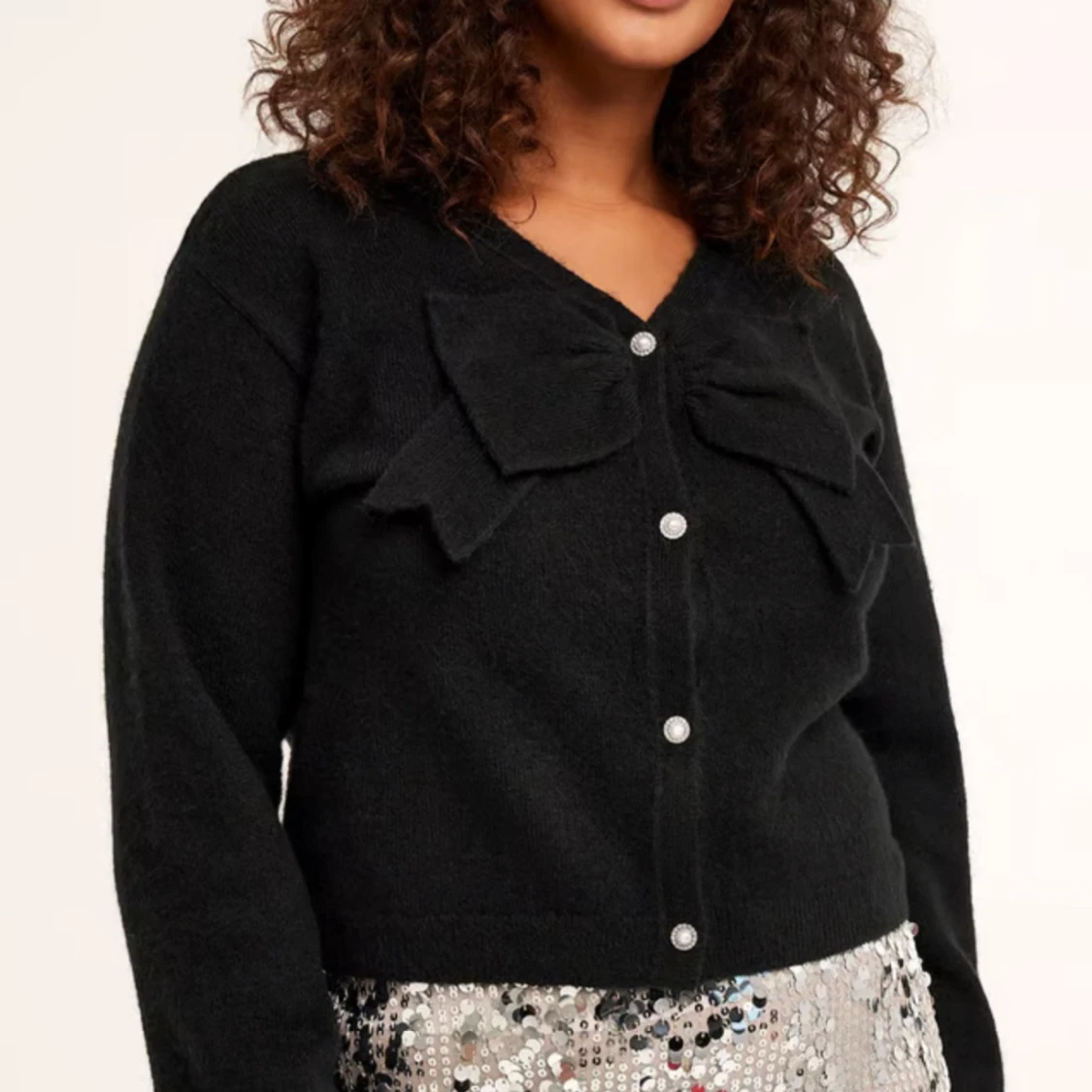 Svart kofta med rosett från Kappahl