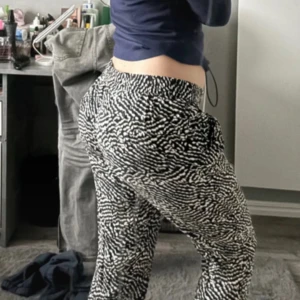 Svartvita mönstrade byxor - Snygga svartvita byxor med ett unikt mönster. De har en bekväm passform och är perfekta för en avslappnad stil. Byxorna är elastiska i midjan vilket ger extra komfort. är i M men passar som S och M