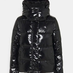 Glansig Calvin Klein Jacka - Jättesnygg vinterjacka från Calvin Klein!🖤 Köptes i vintras helt ny, därför inga defekter eller slitage på jackan den ser ut som ny! Andvänd gärna ”köp nu” funktionen🖤Ny pris 2200kr