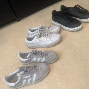 SKOR - Säljer Gizelle Adidas, Puma, samt basic vanliga svarta skor med vit sula nere.   Adidas Gizelle (grå) säljs för 300 kr. Puma säljs för 200kr pga lite slitage. Mer bild finns. Svarta skorna säljs för 200. Inga märkvärdigheter.  Ni står för frakten 