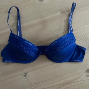 Blå Calvin Klein BH - Har själv aldrig använt den men köpte den på Vinted där det stod att den var varsamt använd. Det är inga spår av användning. Skulle uppsakatta storleken som ungefär 75a.
