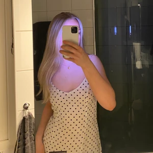 Prickig klänning  - Prickig V-ringad slipklänning från H&M. Kort klänning som sitter fint. Tunn och luftig så passar jättebra nu till sommaren. Slutsåld på hemsidan. Skriv för mer bilder💗 (köparen står för frakt) 