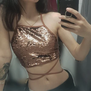 Glittrig Topp - Superfin glittrig y2k topp!!! Snören är ganska lång så du kan justera och ha den lite olika! Använt bara en gång så den är i jättebra skick! (Har dock klippt bort lappen då den störde när jag hade den på mig) Om flera är intresserade så aktiverar jag budgivning<3 3 FÖR 2 PÅ ALLT!  