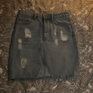 Jeans kjol storlek 38 - Blå jeans kjol med slitningar. Kan mötas i Örebro och Eskilstuna 