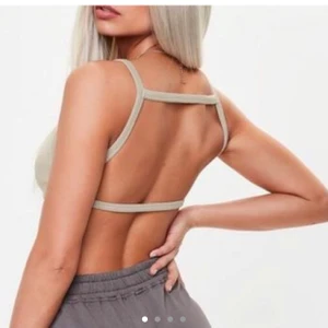 EUC Missguided Nude Camel Brown Strappy Cut Out Bralette XS Kim Kardashian Yeezy  - This ribbed soft bralette features a strappy back, cropped style and nude camel hue.   Regular fit    Tag size US 2 EU 34 95% polyester 5% elastane   Worn for a shoot & hand washed then line dried, NOT machine dried. Gently used excellent used condition. No holes, tears, rips, stains, snags. Smoke and pet free storage space. No other flaws to note. Itchy care machine tags have been carefully cut off.  Happy to bundle. Will gladly take more pics.   Disclaimer: Please expect some general wear in all secondhand pre-owned items as they have lived a previous life, so do not expect a mint item.
