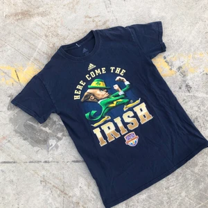 COLLEGE TEE!! 🏈🏈 - Sjukt snygg college t-shirt producerad av Adidas åt Notre dame, Indiana och deras Amerikanska fotbollslag Fighting Irish från National Championship 2013. Tröjan är S men passar något mindre. Sjukt snyggt tryck. Tröjan är även i grymt skick och inga direkta defekter. Tveka inte att höra av dig om du undrar något! 🌱✌🏻🏈