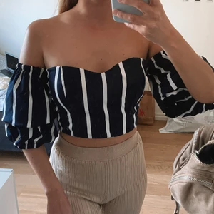 Randig offshoulder top med puffärm - Blå/vit randig offshoulder top med puffiga ärmar & som är croppad! Inbyggda kupor som är vadderade så behövs ej bh under! Köpt i Spanien, står ej storlek men skulle säga att den passar xs-s! Frakt ingår i priset!