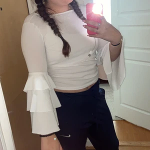 En vit topp med volanger på armarna  - En vit topp med volanger som tyvärr  inte kommer till användning den ser genomskinlig ut men den är inte de de ba att den är för liten för mig 🥰