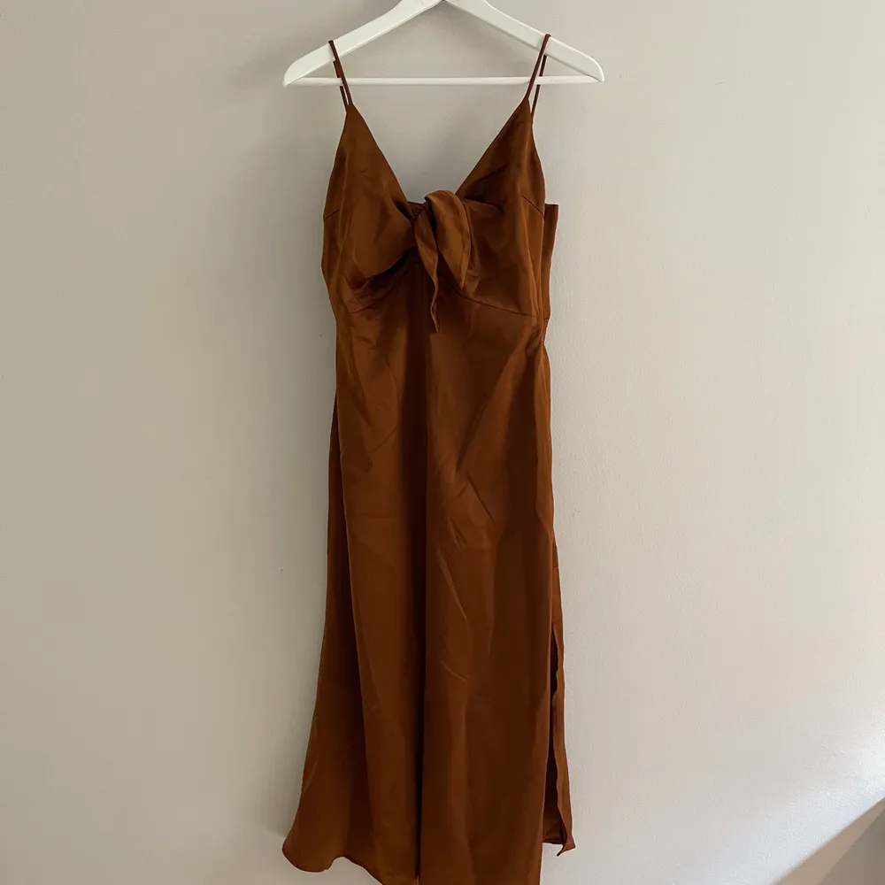 Oanvänd klänning i rostbrun satin. . Klänningar.