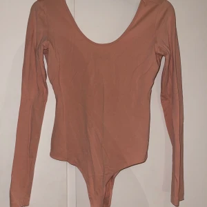 Sting body  - En rosa/beige sting body med fin urringning. Använder inte längre