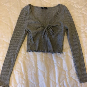 Grå tröja med knytning  - En grå tröja med knytning där fram, köptes på shein för ca 90kr. Väldigt stretchig o passar de flesta skulle jag säga💓 betalning via swish 