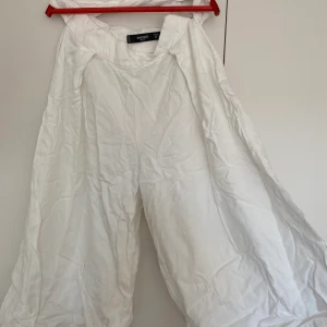 Vita byxor från mango - Vita flowiga byxor från mango, de har två band så man kan knyta runt. Skriv till mig för fler bilder😊😊 de har bara använts några gånger