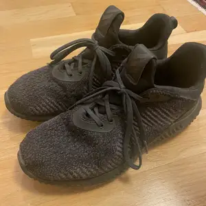 Black sneakers with some wear inside
