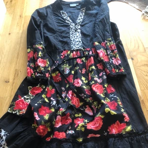 Sommarklänning i svart med mönster 34/36 - Svart tunn sommarklänning med både blommor och leopard mönster.