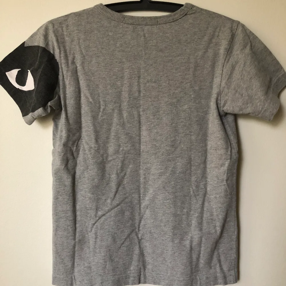 CDG Play / Comme Des Garçons Grey T-Shirt  Size small, fits like a regular size small.  Excellent condition, no flaws or damage.  DM if you need exact size measurements.   Buyer pays for all shipping costs. All items sent with tracking number.   No swaps, no trades, no offers. . T-shirts.