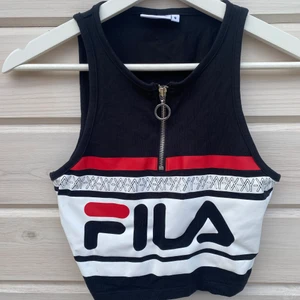 Fila Crop top - Fila crop top aldrig använd då den var för liten för mig. Väldigt snygg och önska jag kunde ha denna, har en liten blåfläck på tröjan som jag ej vet vad det är eftersom den legat i garderoben sen jag köpte den men syns ej så mycket. Betalning sker via Swish. 