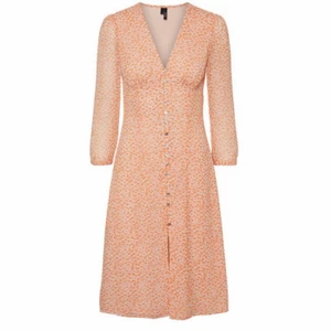 Sommarklänning - Sötaste sommarklänningen från vero moda, påminner om adoore!!! Helt slutsåld i denna vackra peachy färg. Dragkedja på sidan men alla knappar går även att öppna. I nyskick, prislapp kvar, säljer då den tyvärr inte var min stil. Orginalpris 500