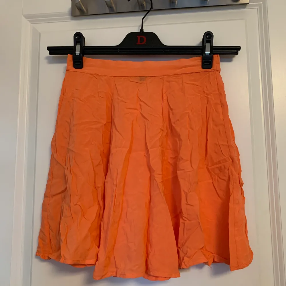 Orange/pärsika-färgad kjol från BikBok i storlek XS. Det är resår i bak så den är stretchig. . Kjolar.