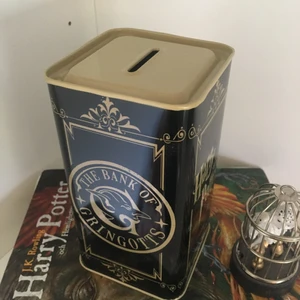 Rumdekor-Harry Potter kassaskåp - Ett litet kassaskop som det står ”Harry Potter” och ”Bank of Gringots” på. Burken går att öppna i botten. Jättefin dekoration och helt oanvänd. Den har bara stått i ett hörn sen jag fick den. Ca 7cm bred och 14cm hög. Frakt tillkommer