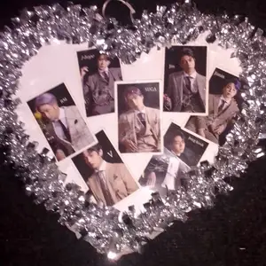It's a decoration piece handmade, and it has 7 photocard on it with a silver heart. 