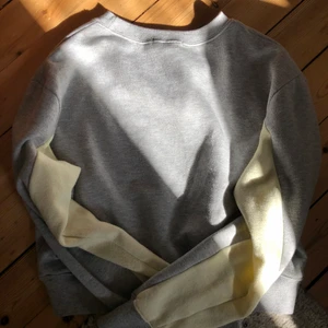 Grå sweatshirt - Grå sweatshirt från bikbok med ljus gula ärmar! Jätte mjuk inuti så mysig att ha på sig. Köpt för 300 kr, säljer för 70 + frakt