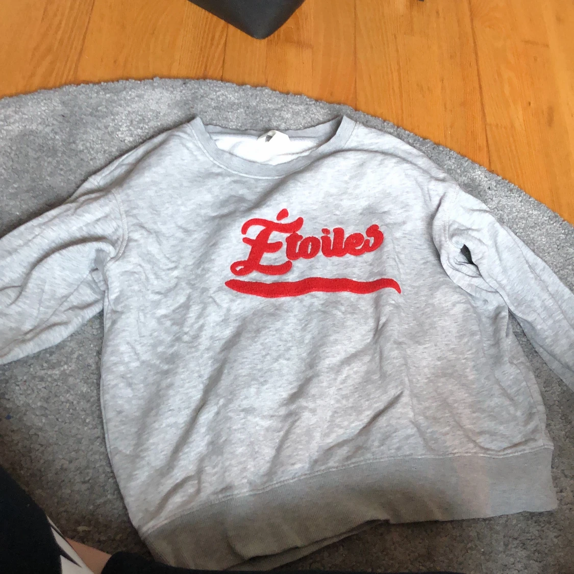 Grå sweatshirt med rött tryck. 