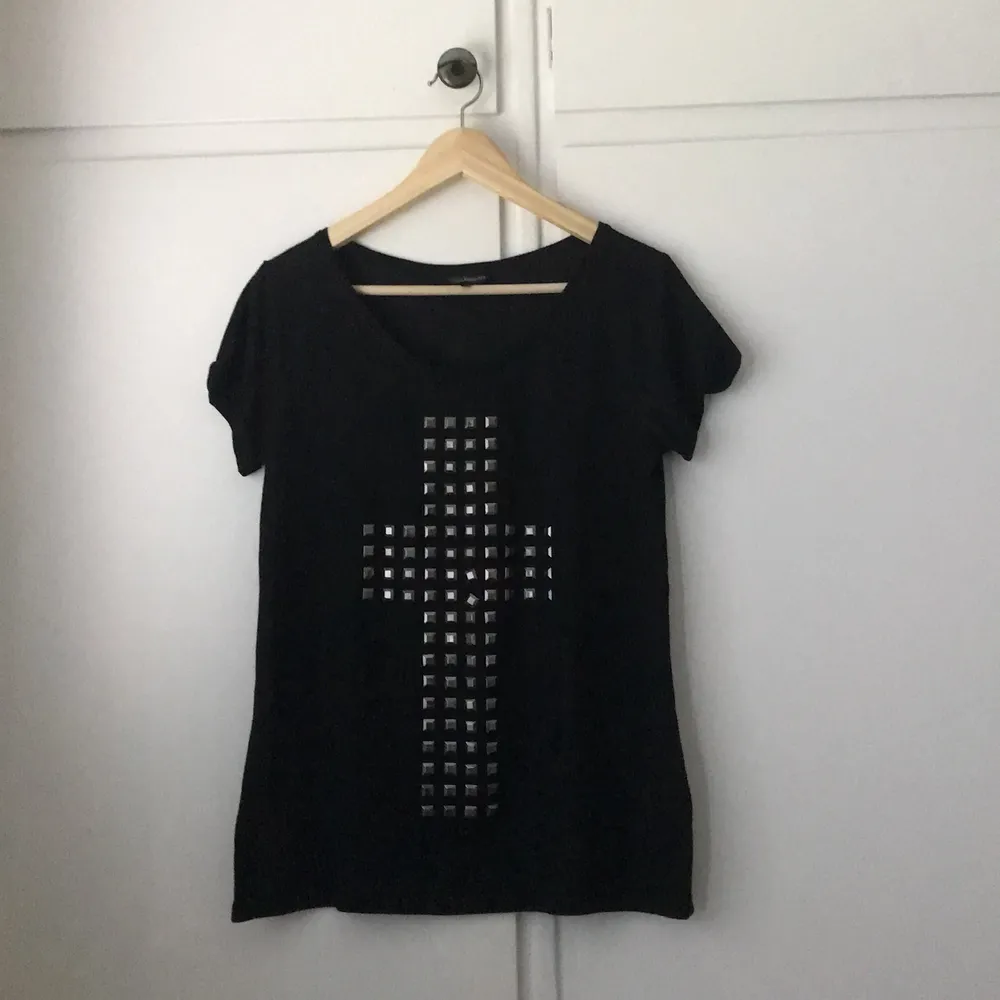 Cool svart luftig t-shirt med ett stort nit-motiv av ett kors.. T-shirts.