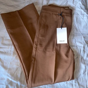 Suit Pants - Sally Brown - • Högmidjad kostymbyxa med stråveck • Nypris: 599.00kr • EU36-L28 • Endast testade