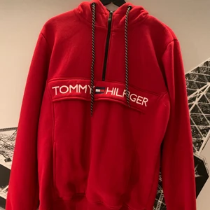 Röd Tommy Hilfiger hoodie - Säljer denna hoodie pågrund av att den inte passar i min stil men är i skit bra skick där den är i 9,5/10 för att de inte finns några skador på den eller något annat av de.Denna hoodie är i Storlek L men passar väldigt bra till dom som har M i hoodies och ja rekommenderar denna hoodie pågrund av att den är perfekt till sommarkvällarna när de blir lite mer kyligt.Nypris 899kr.Priset kan sänkas vid kontakt