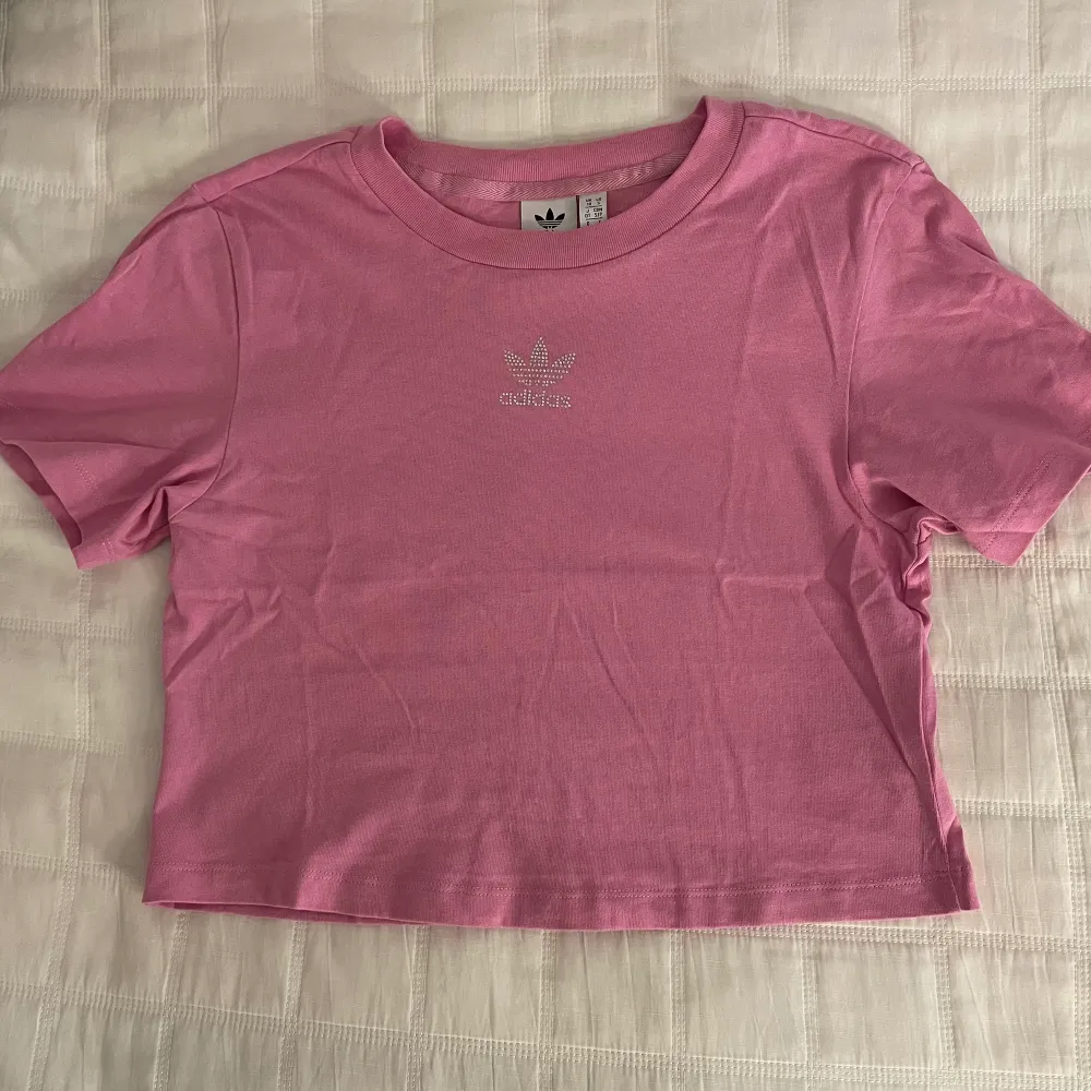 Cropped rosa, oanvänd t-shirt. Snygg detalj fram på bröstet. Bara legat i garderoben utan att komma till användning! 💕. T-shirts.