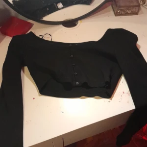 Tröja - Svart långärmad tröja med knappar på framsidan. Möts gärna upp.