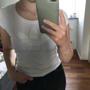 T-shirt  - Vit t-shirt från Adidas i storlek XS. Kan även passa S men är då lite tajt, som på bilden. 