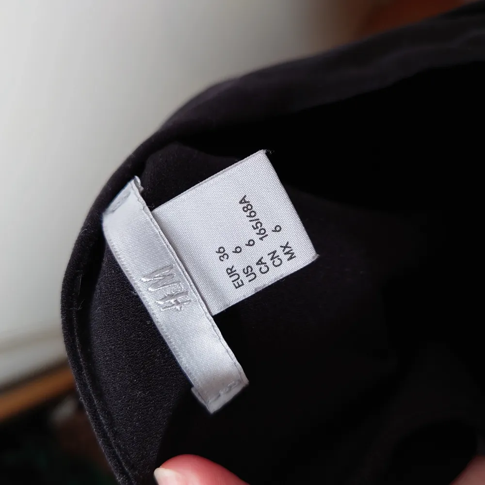En svart byxdress med dragkedja i sidan. Den knyts med band i midjan och i nacken🌱. Jeans & Byxor.