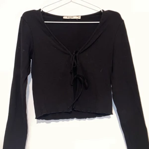 Knytblus - Svart knytblus. Storlek Xs men passar även S. Från NLY. Två knuten som går att knyta som man vill. Man kan ha den utan eller med en tröja under, jag föredrar utan. Skönt material men har inte kommit så mycket till användning för mig. Kan fixa bilde hur den sitter på. 