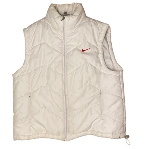 Nike väst - Vit nike väst, lite av färgen har gått av på dragkedjan på fickorna annars väldigt bra skick. Står XL men skulle säga S eller M