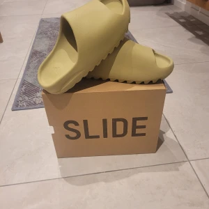 Yeezy Slide  - helt nya Yeezy slide från det senaste släppet hos adidas,färgen är grön ! Tyvär är dom för små för mig det är storlek 44 1/2 [små i storlekarna]  100 % äkta  Gör byten så bara skicka om har något annars 900 kr 