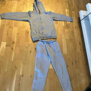 Mckenzie dress - Grå mckenzie dress, väldigt bekväm och extremt bra skick! Knappt använd och inga konstigheter. Säljer då jag har bytt stil och orginalvärde 450kr. Storlek 13-15. Du kan också köpa byxor elr hoodie inviduellt (pris diskuteras)