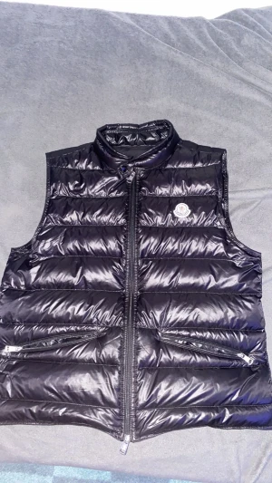 Moncler väst - Hej vill nu sälja min väst så är i bra skick. Den är storlek L men passar M.Den är äkta såklart och kan skicka flera bilder vid begäran. Ny pris 6000kr. Finns att hämta i Sundbyberg eller fraktas.