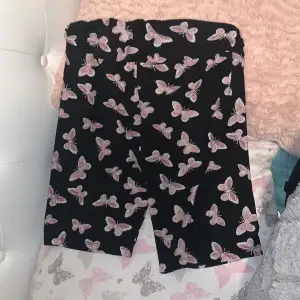 Black biker shorts with pink butterflies 