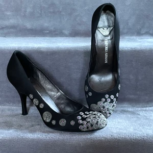 Skor Armani - Sidenpumps med brodyr i silver och lila. Använda endast ett fåtal gånger, i mycket fint skick. Nypris 3900kr