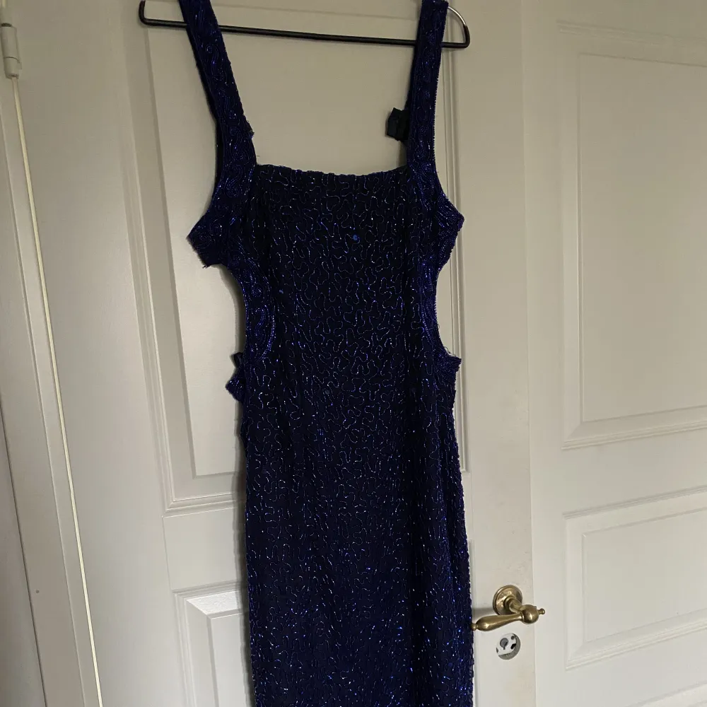 Säljer den här otroligt vackra långklänning med mörkblåa pärlor av glas. Köpte klänningen second hand men den var för liten för mig. Den är xs eller xs/s. Klänningen är ner till marken på mig som är 170 cm.  Bara skriv om ni vill ha fler bilder! 💙. Klänningar.