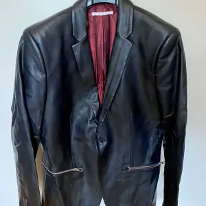 I bought it at Macy’s in Miami Beach for $200. Never worn. Faux leather ultra slim fit with silver zippers. After storage in a case the collar got broken.